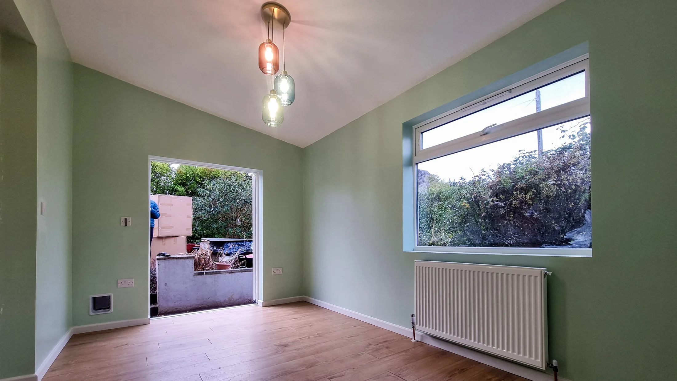 Completed guest room with a large window and garden opening