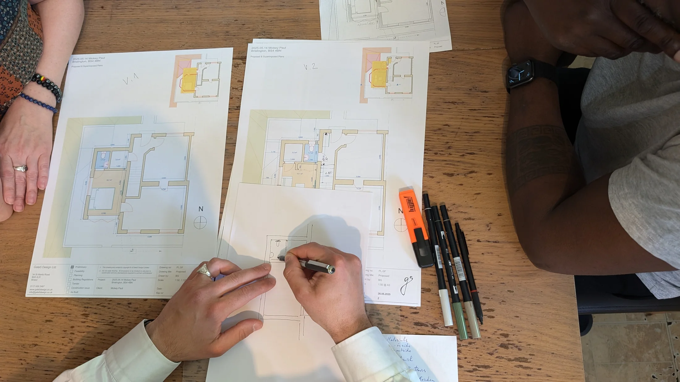 Printed extension plans and hand sketches being developed