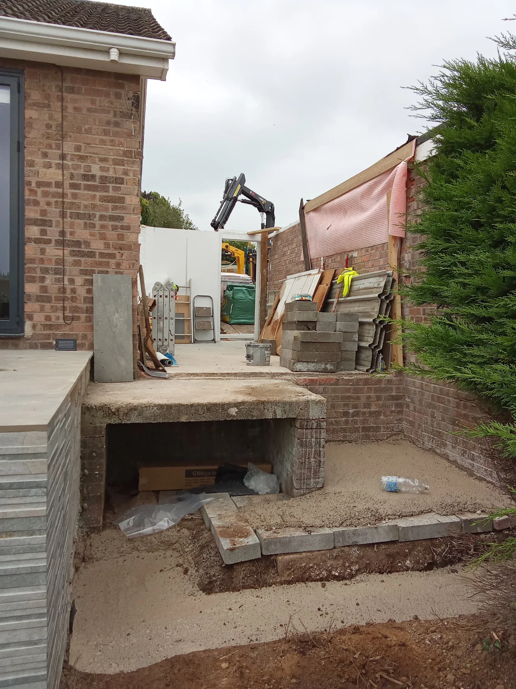 Existing rear garage entrance and steps during early site preparation
