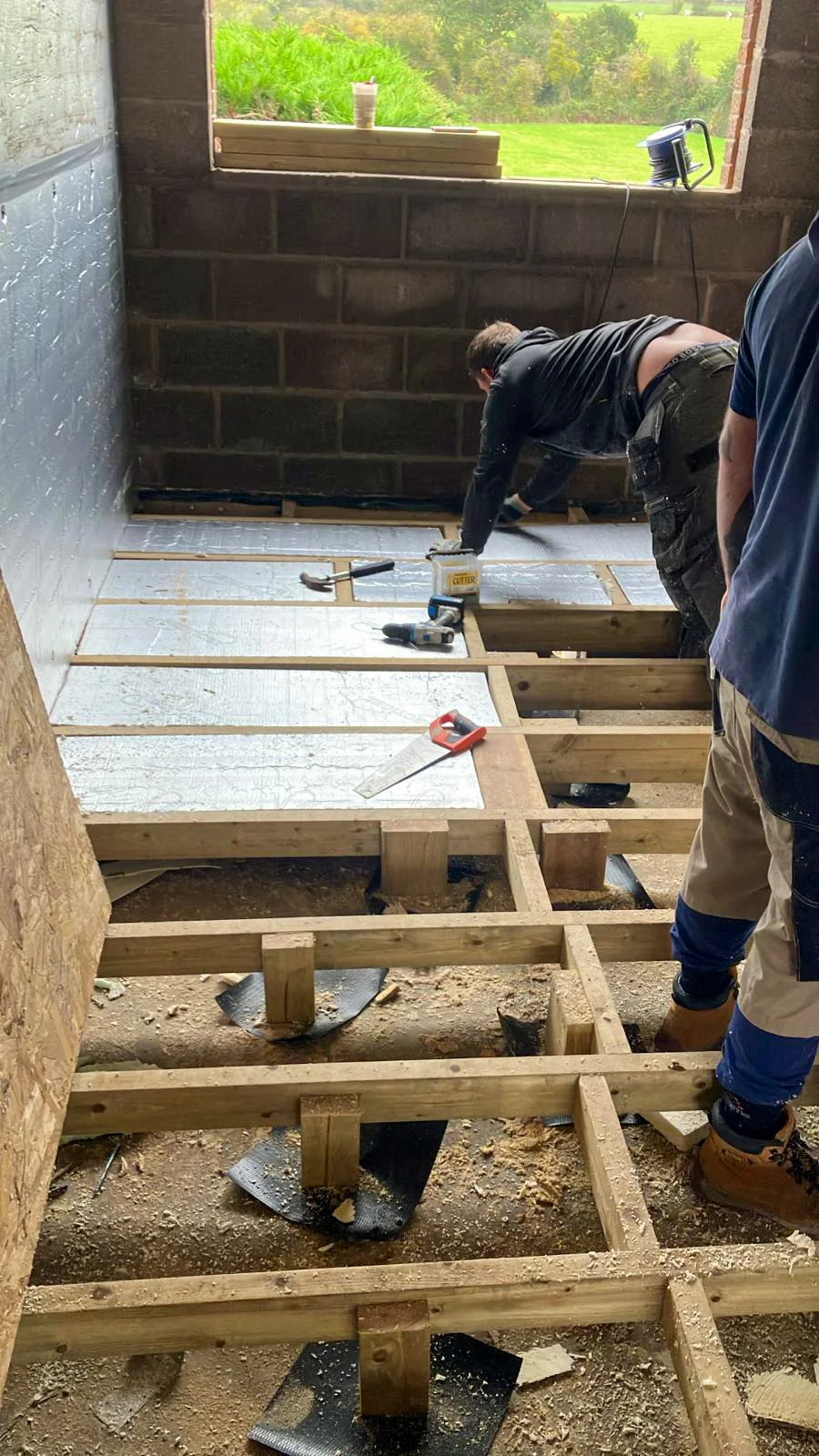 Timber floor framing and insulation inside the garage conversion
