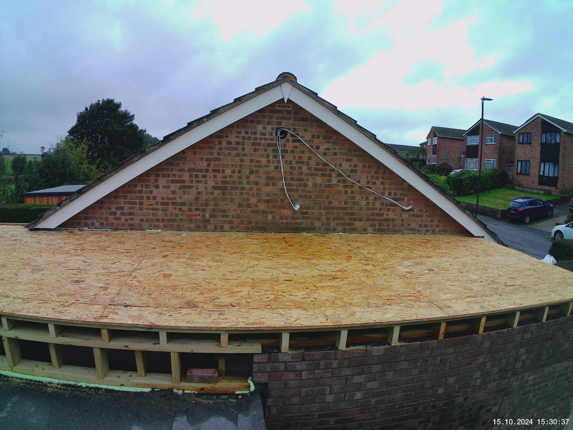 New timber roof deck and framing beside the existing brick gable