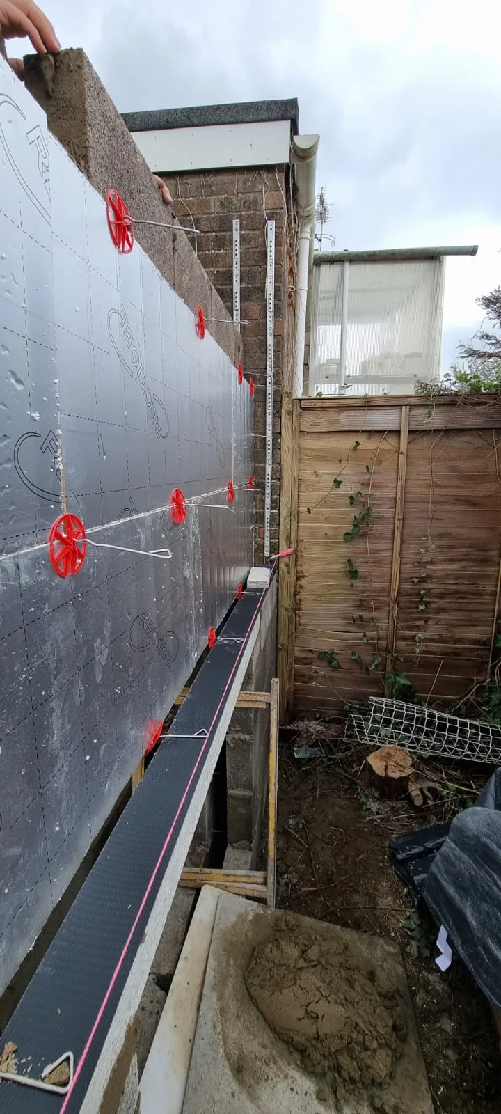 Insulation installed beside the garage wall during construction