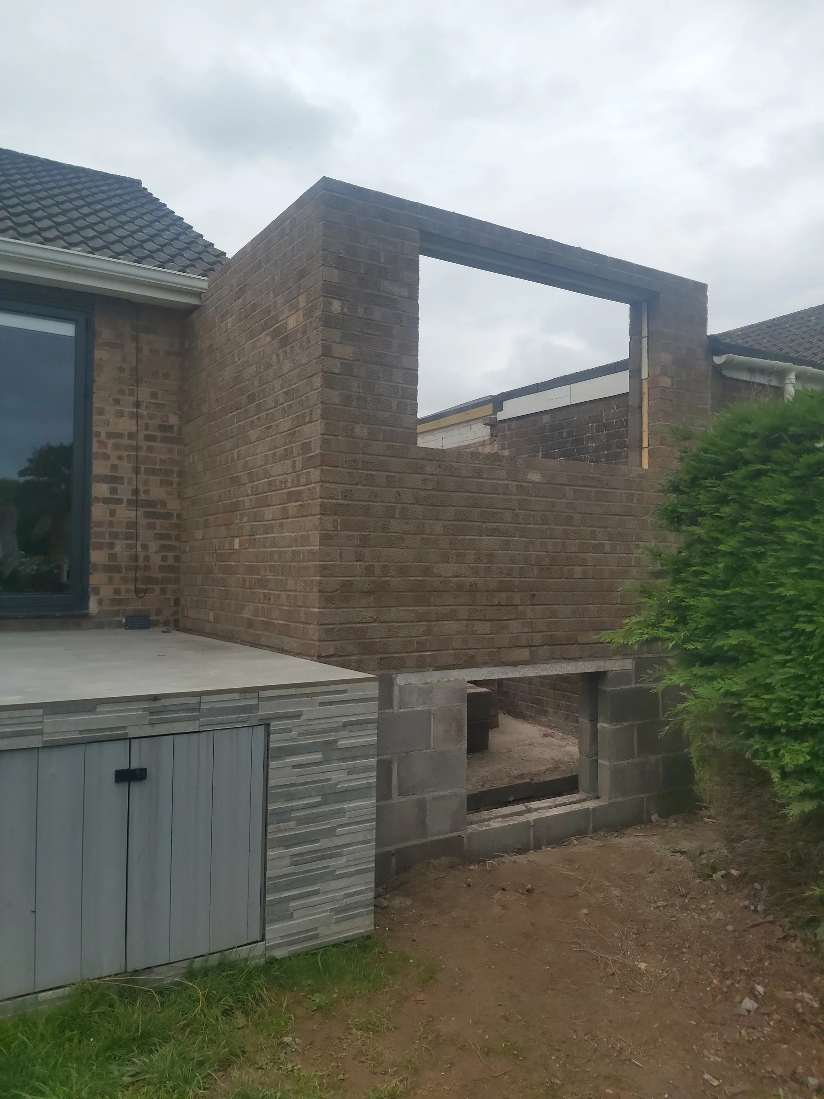 New blockwork at the rear of the garage with a large window opening