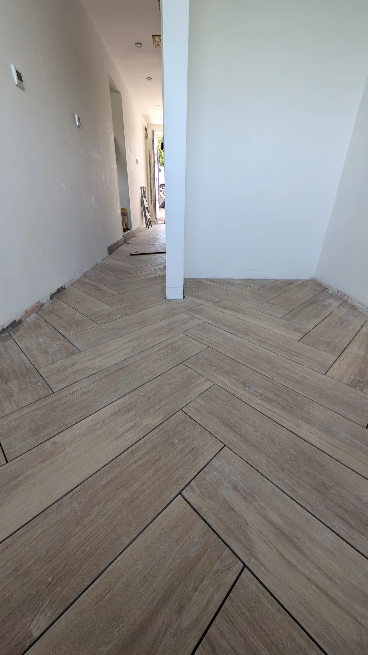 Patterned floor tiles extending through the interior