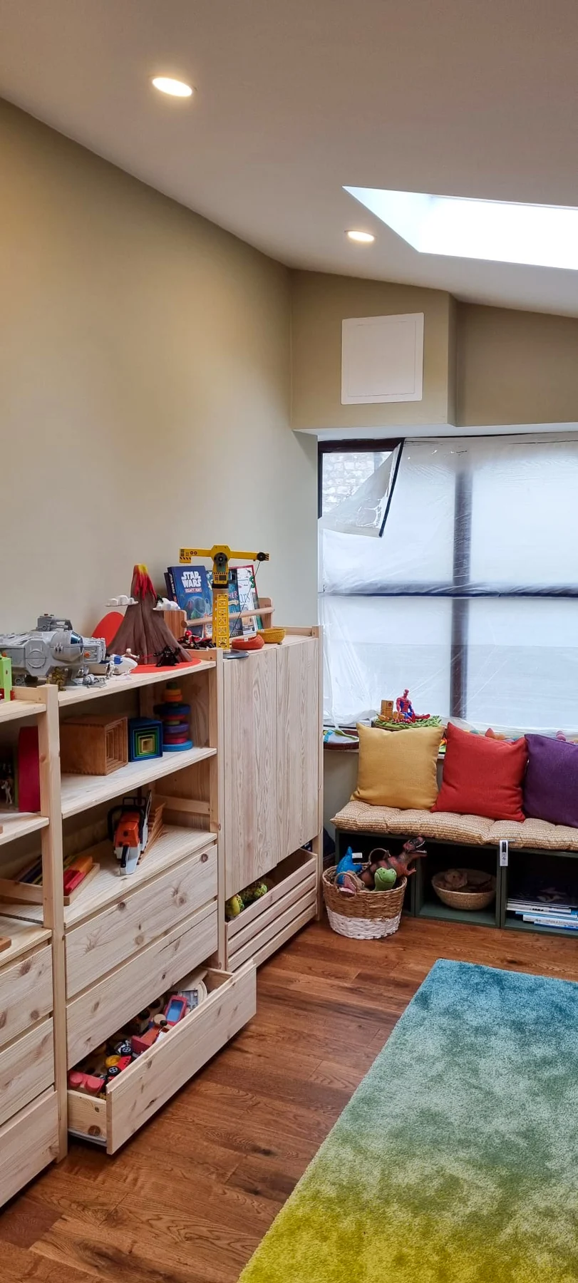 Completed room with timber flooring and storage