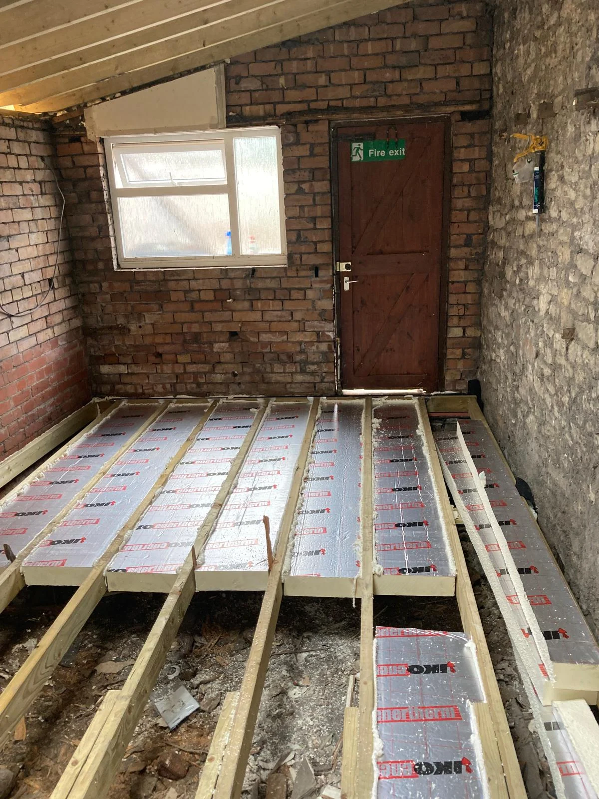 New floor joists and insulation being installed