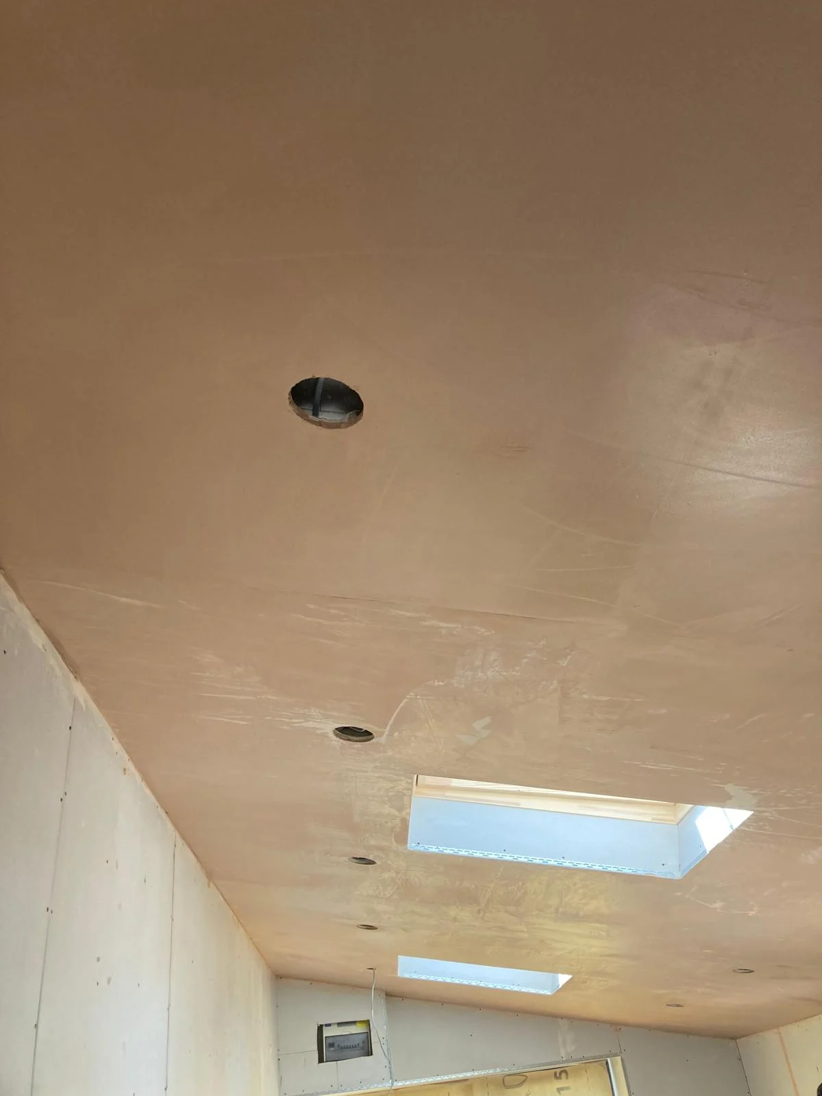 Fresh plaster on the ceiling around a rooflight