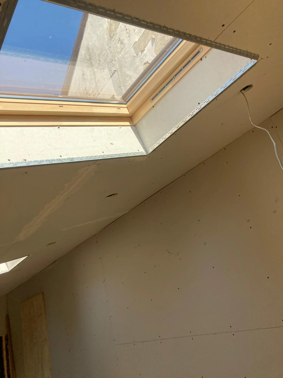 Plasterboard lining around a rooflight