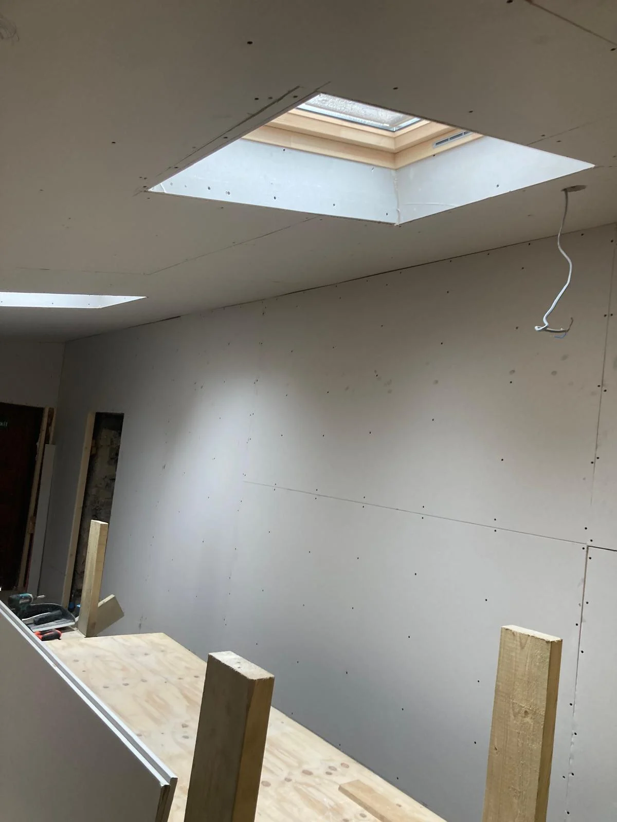 Plasterboard installed on the room walls and ceiling