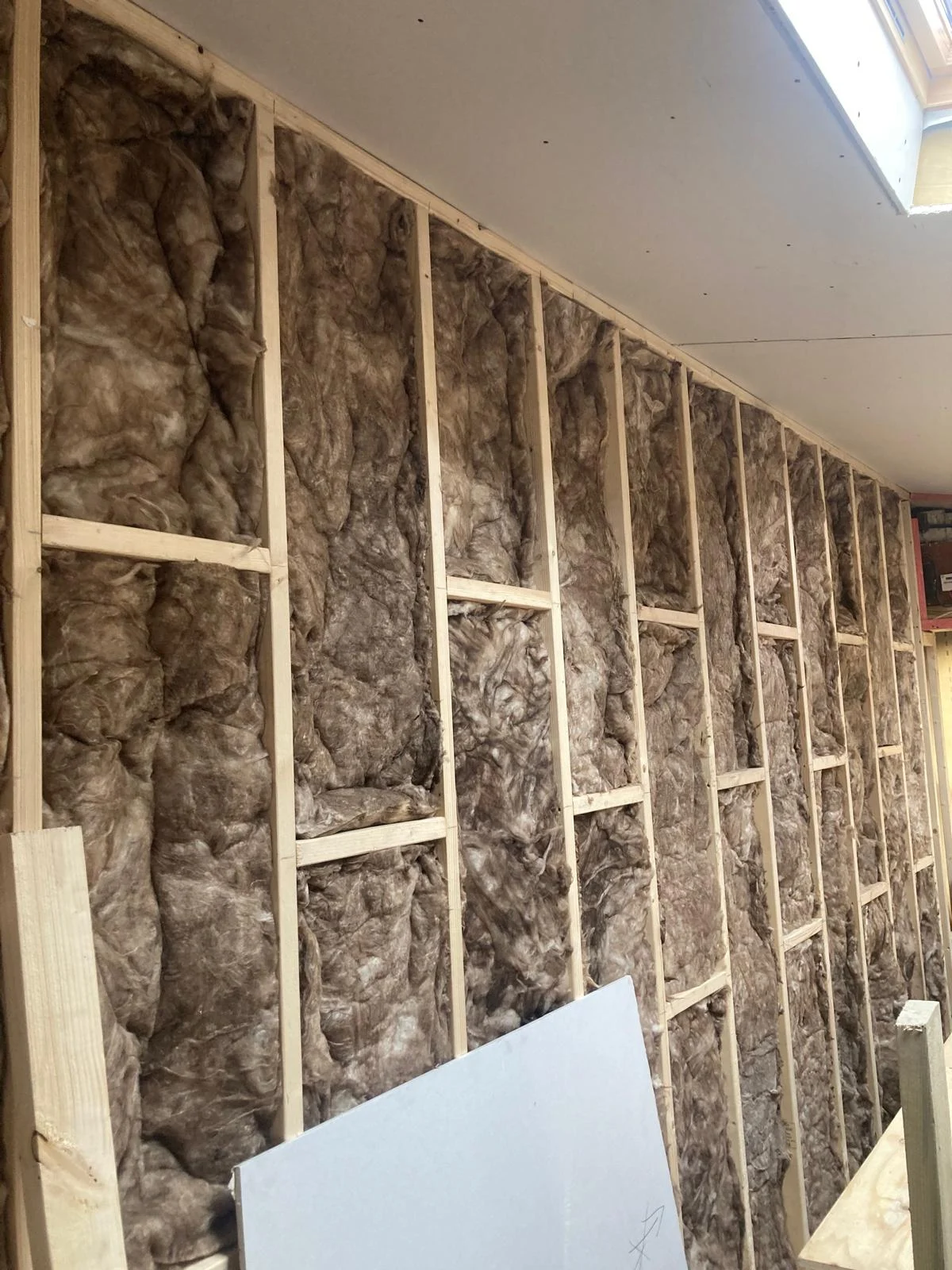 Insulation fitted between the new wall framing