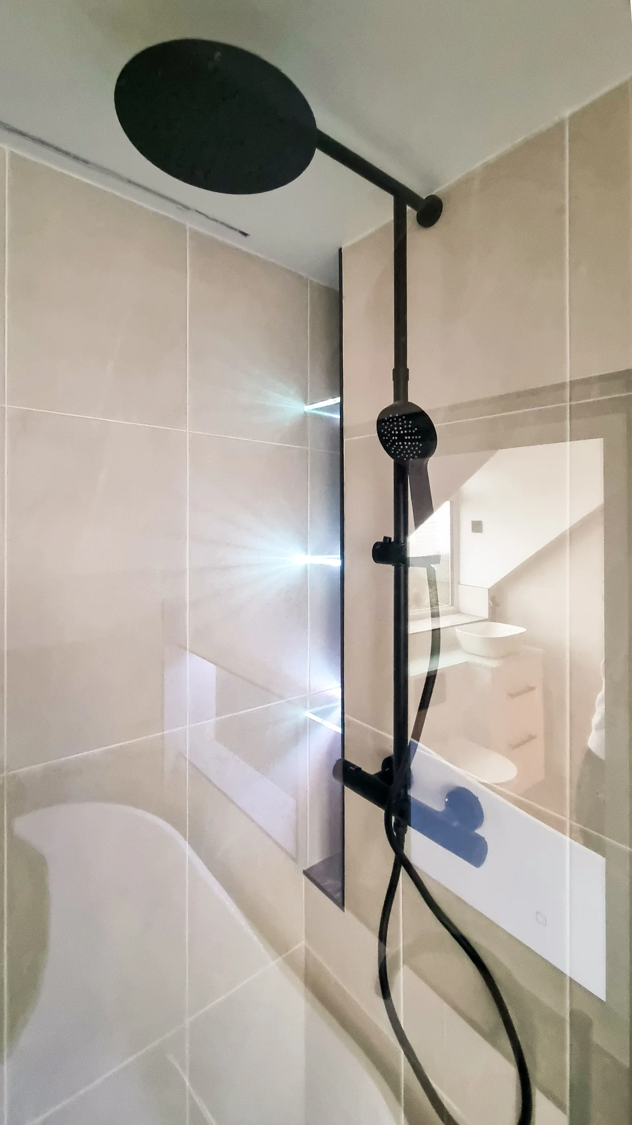 Black rainfall shower and illuminated shelving